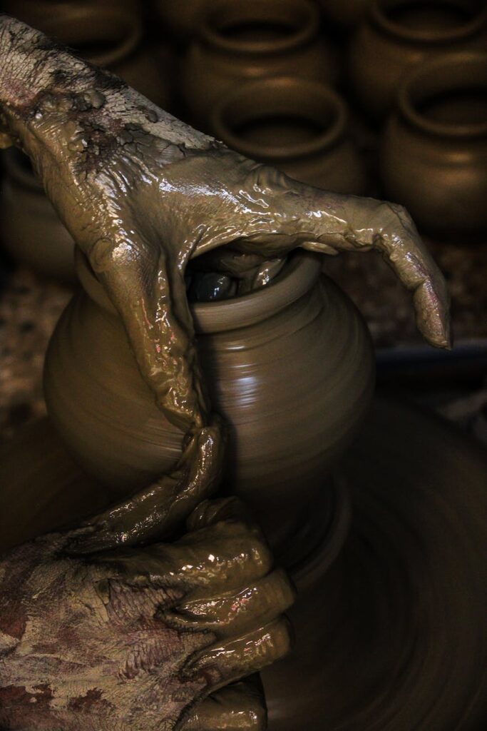 photo of person making clay pot